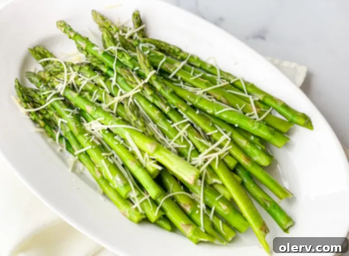 Perfectly Crispy Air Fryer Asparagus 5 Perfectly air-fried asparagus spears with a hint of crispiness, served on a plate.