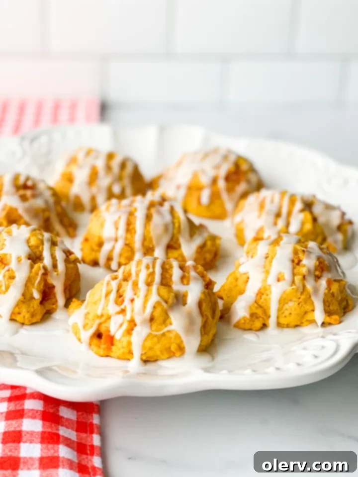 Chewy Spiced Carrot Cake Cookies 6 A plate of delicious carrot cake cookies, some with icing, ready to serve.