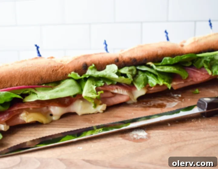 Artisan Baguette 3 A close-up view of the prepared baguette sandwich, showcasing the generous fillings before being sliced for serving.