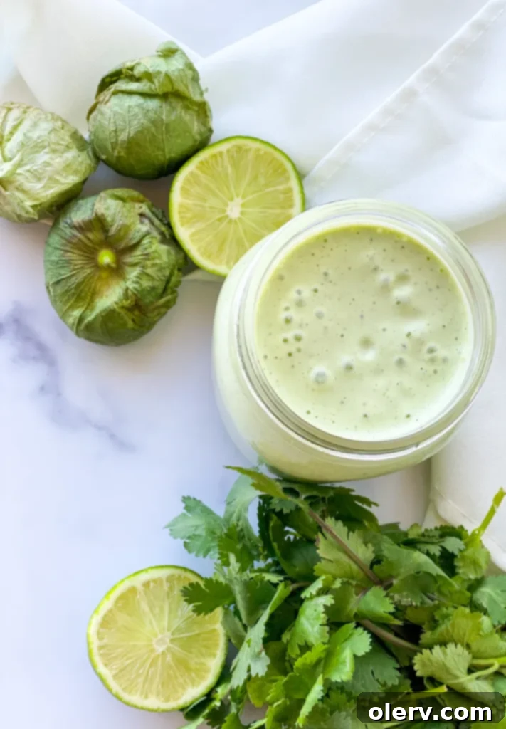Zesty Cilantro Tomatillo Vinaigrette 6 A vibrant taco salad with various fresh toppings, generously drizzled with the creamy cilantro tomatillo dressing.
