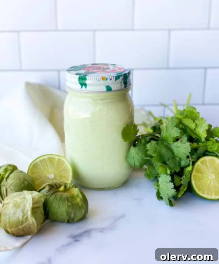 Zesty Cilantro Tomatillo Vinaigrette 7 A large serving bowl filled with a vibrant salad, topped generously with creamy cilantro tomatillo dressing and fresh garnishes.