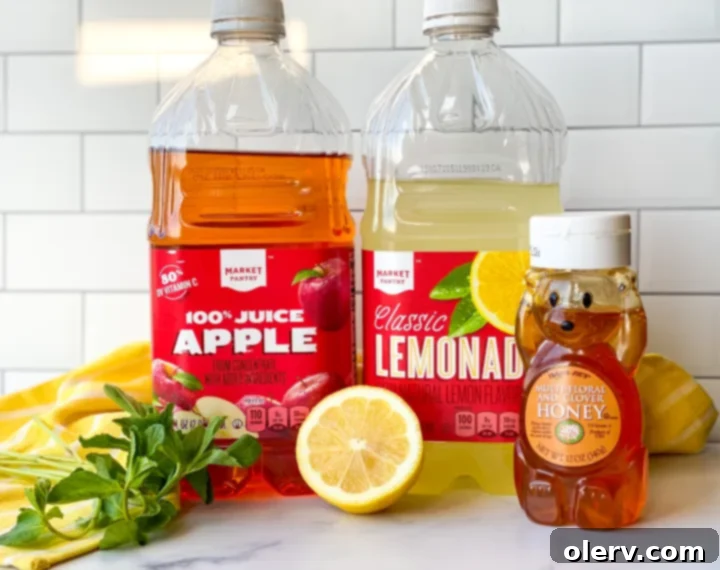 Golden Honey Apple Lemonade 4 Two glasses of Honey Apple Lemonade with mint and apple slices