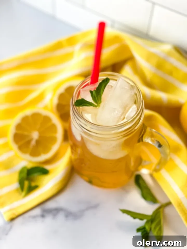 Golden Honey Apple Lemonade 5 Close-up of a glass of Honey Apple Lemonade with mint garnish