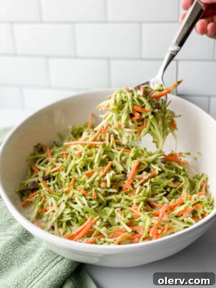 Zesty Broccoli Power Slaw 2 Freshly prepared creamy broccoli slaw salad in a white bowl, ready to be served