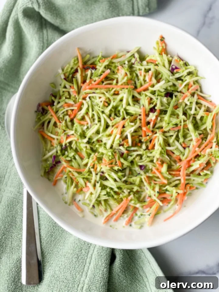 Zesty Broccoli Power Slaw 3 Close-up of shredded broccoli and other vegetables, forming the base of a vibrant broccoli slaw