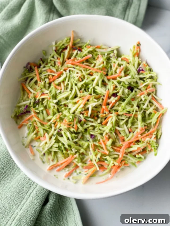 Zesty Broccoli Power Slaw 4 A bowl of rich, creamy dressing ingredients being whisked together, showing the texture