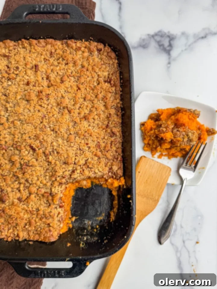 Golden Sweet Potato Delight 2 A beautifully baked sweet potato casserole with a golden pecan topping, ready for serving.