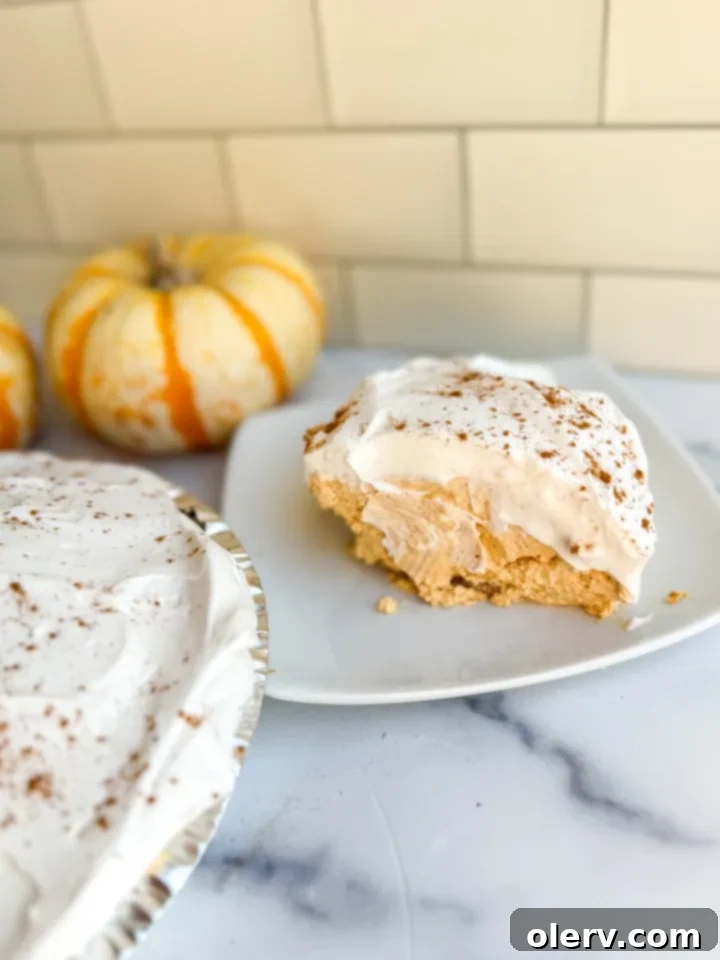 Cloud-Nine Pumpkin Pie 4 Essential ingredients for Pumpkin Fluff Pie laid out on a kitchen counter: cream cheese, Cool Whip, pumpkin puree, and spices.