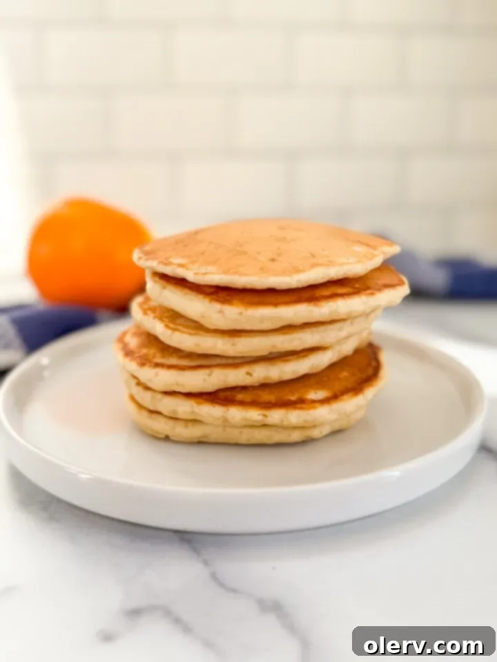 Buttery Fluffy Pancakes 3 Close-up shot of pancake batter being poured onto a hot griddle