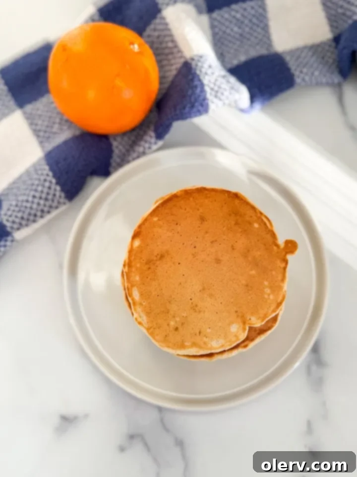 Buttery Fluffy Pancakes 6 Pancakes being drizzled with maple syrup